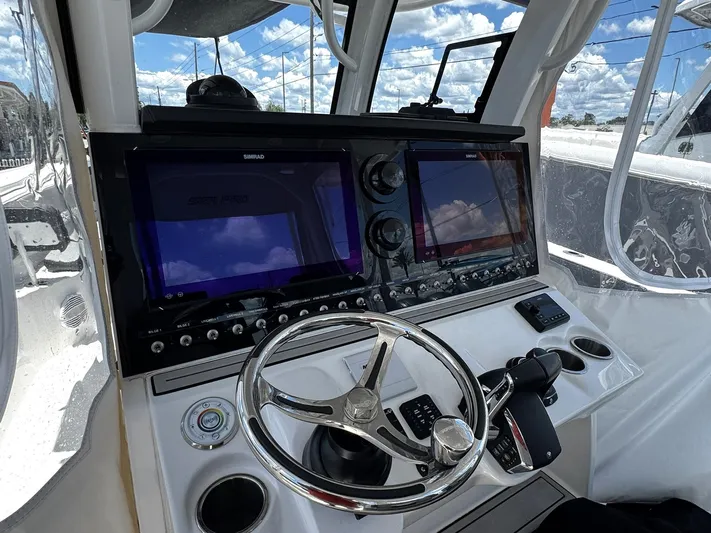  Yacht Photos Pics 2024 Sea Pro 322 DLX boat dashboard with steering wheel and navigation screens.