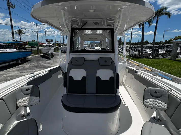  Yacht Photos Pics 2024 Sea Pro 322 DLX boat interior with seating and helm, parked at a marina.