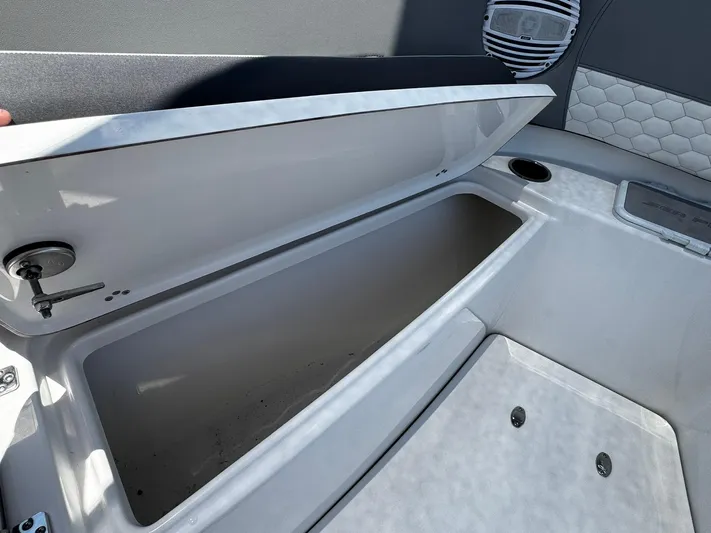  Yacht Photos Pics 2024 Sea Pro 322 DLX boat storage compartment with open lid, showcasing interior space.