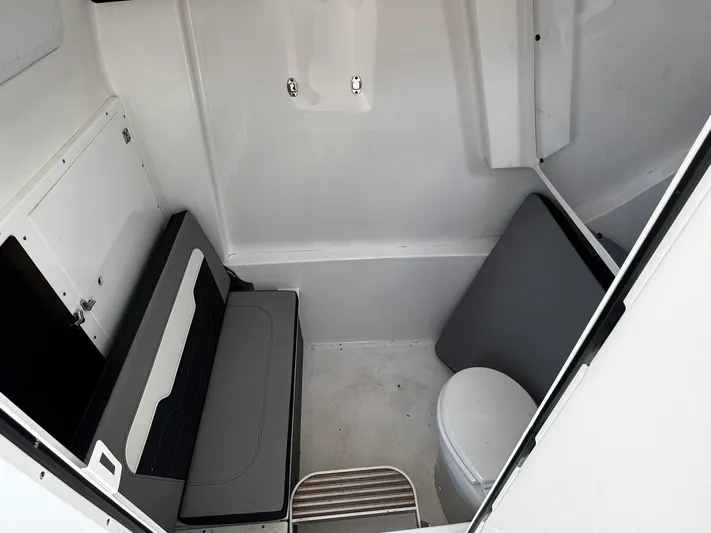  Yacht Photos Pics 2024 Sea Pro 322 DLX boat interior with seating and toilet.