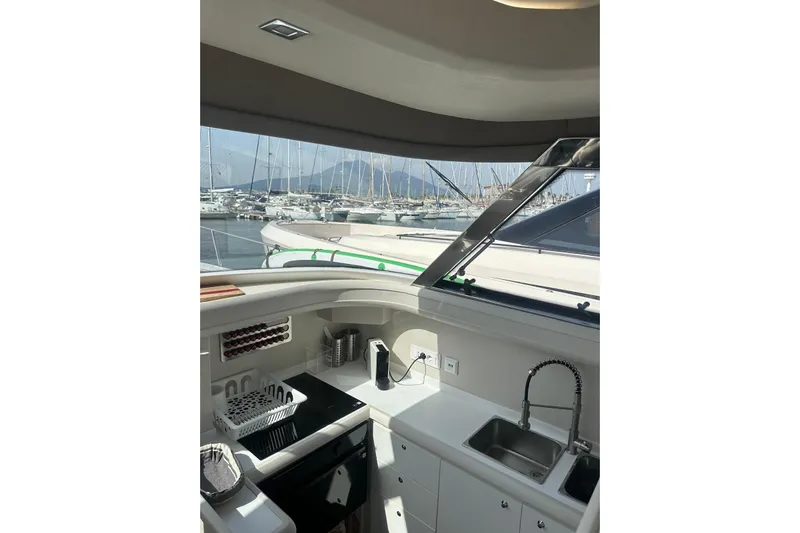  Yacht Photos Pics Interior view of 2005 Mochi Dolphin 51 yacht kitchen with marina backdrop.