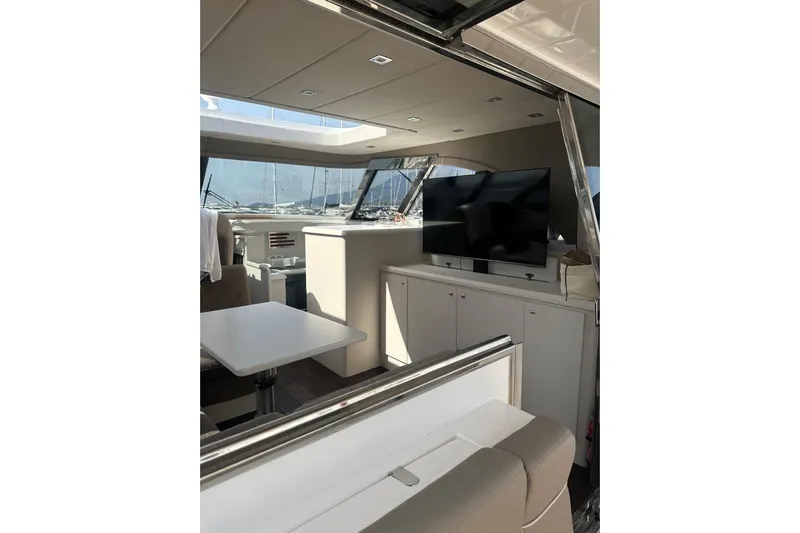  Yacht Photos Pics Interior of 2005 Mochi Dolphin 51 yacht with modern seating and large TV.