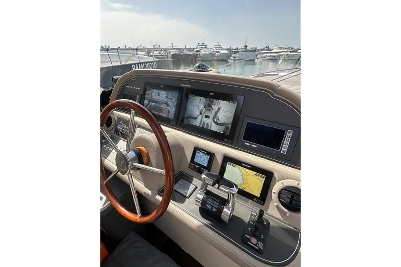  Yacht Photos Pics Helm of 2005 Mochi Dolphin 51 yacht with navigation screens and controls.