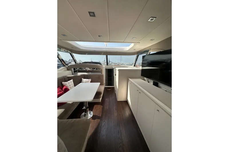  Yacht Photos Pics Luxurious interior of 2005 Mochi Dolphin 51 yacht with modern furnishings and large windows.