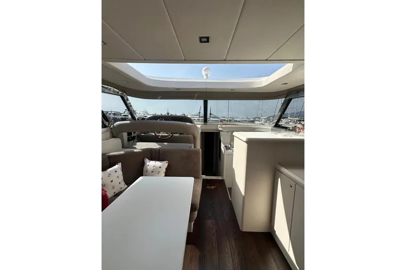  Yacht Photos Pics Interior of 2005 Mochi Dolphin 51 yacht with modern seating and large windows.