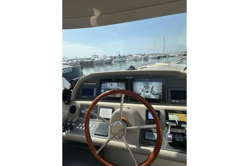  Yacht Photos Pics Cockpit view of 2005 Mochi Dolphin 51 yacht with marina in background.
