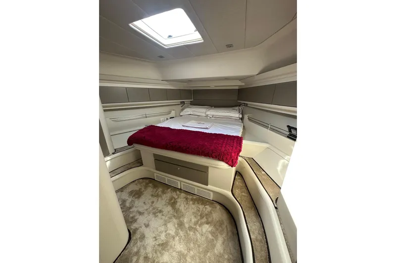  Yacht Photos Pics Luxurious cabin interior of 2005 Mochi Dolphin 51 yacht with plush bedding and skylight.