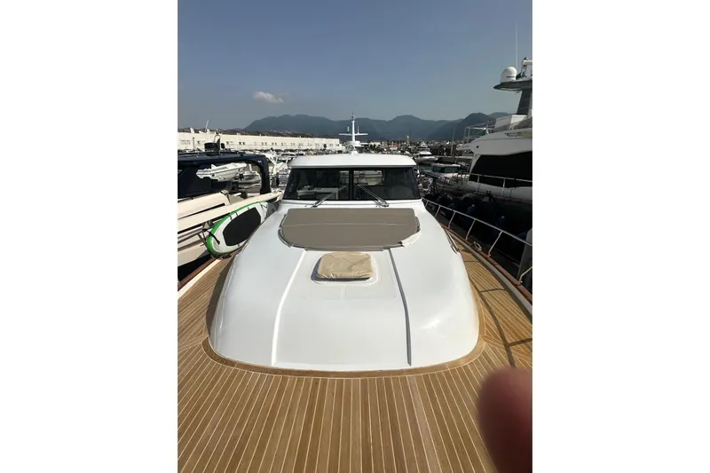  Yacht Photos Pics 2005 Mochi Dolphin 51 yacht docked at marina, showcasing sleek design and spacious deck.