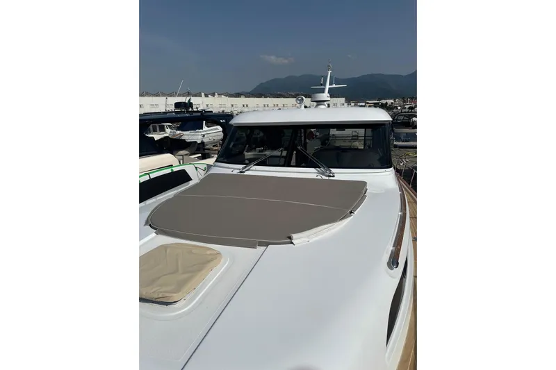  Yacht Photos Pics 2005 Mochi Dolphin 51 yacht with sunpad, docked in marina under clear sky.