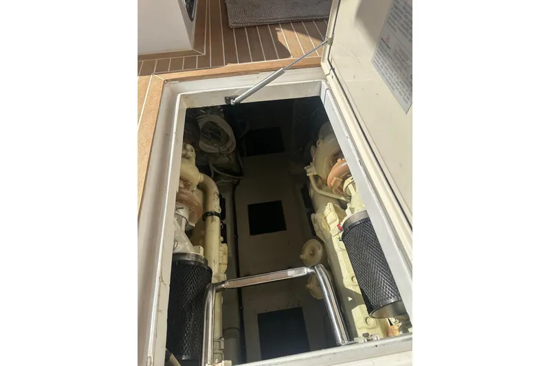  Yacht Photos Pics Engine compartment of a 2005 Mochi Dolphin 51 yacht, showcasing mechanical components.