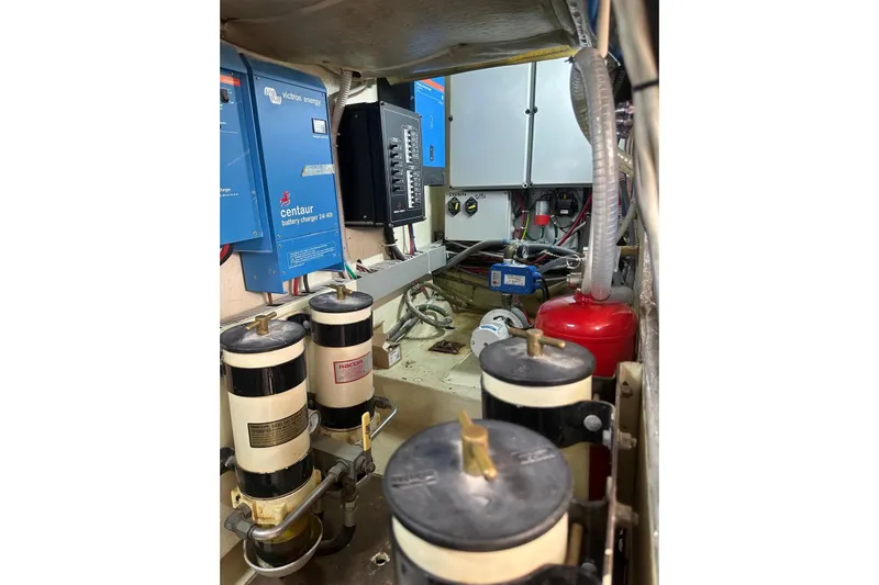  Yacht Photos Pics Engine room of 2005 Mochi Dolphin 51 yacht with battery chargers and filters.