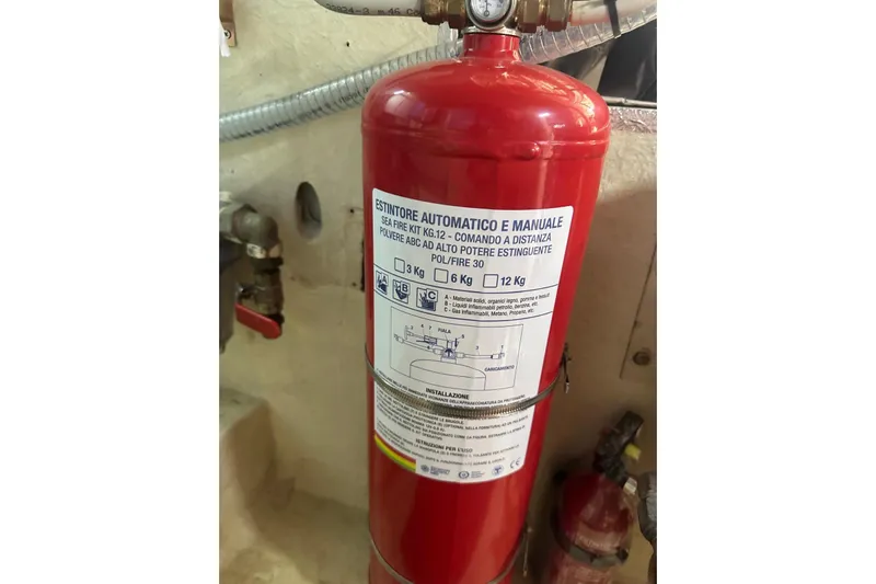  Yacht Photos Pics Red fire extinguisher on Mochi Dolphin 51 yacht, 2005 model, with safety instructions.