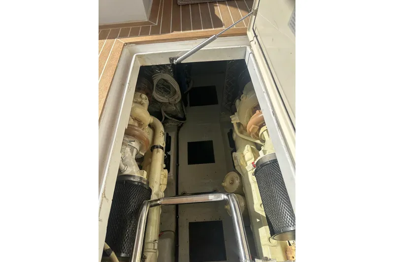  Yacht Photos Pics Engine compartment of 2005 Mochi Dolphin 51 yacht, showcasing mechanical components.