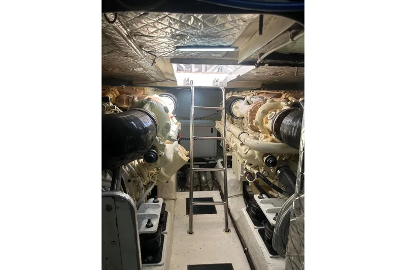  Yacht Photos Pics Engine room of 2005 Mochi Dolphin 51 yacht with visible machinery and ladder.