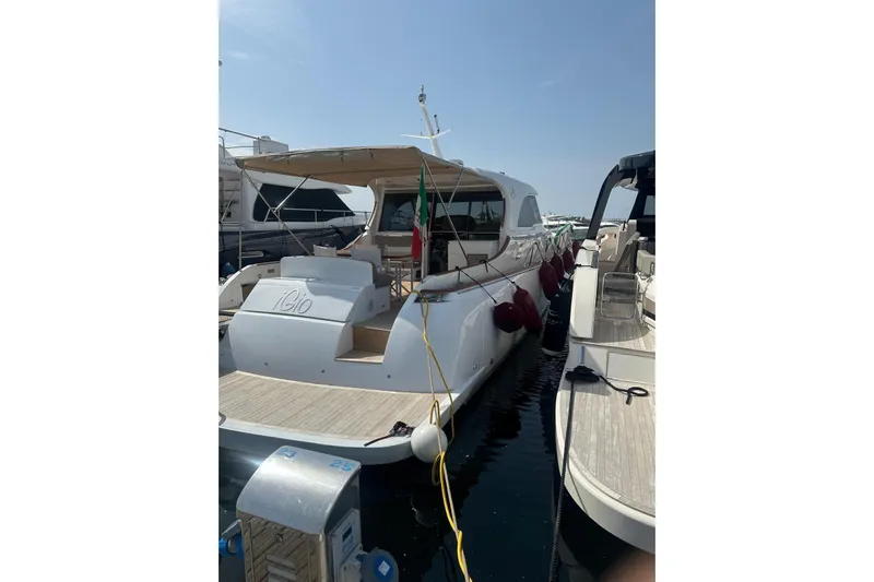  Yacht Photos Pics Luxury Mochi Dolphin 51 yacht, 2005 model, docked at marina under clear sky.