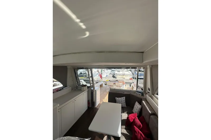  Yacht Photos Pics Interior of 2005 Mochi Dolphin 51 yacht with seating and table, dock view.