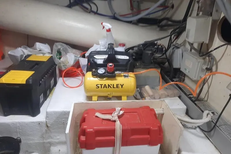  Yacht Photos Pics Engine room of 2005 Mochi Dolphin 51 with Stanley air compressor and tools.