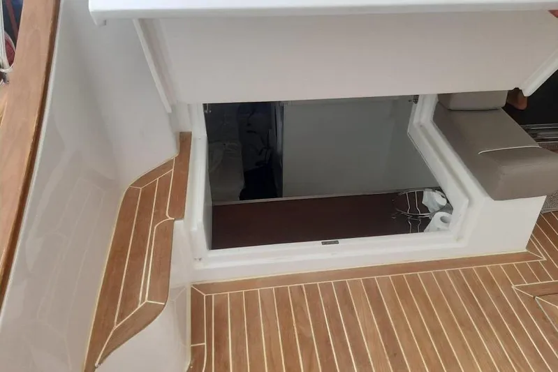  Yacht Photos Pics Interior view of 2005 Mochi Dolphin 51 yacht with wooden flooring and seating.