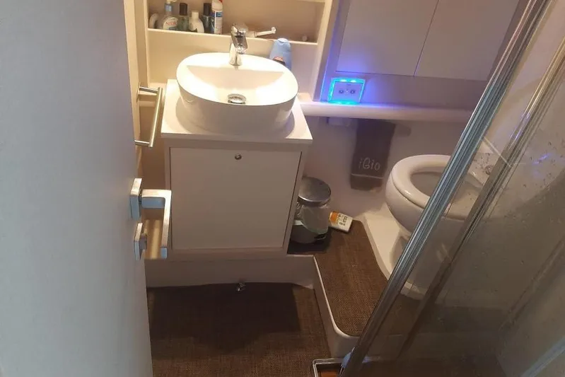  Yacht Photos Pics Compact bathroom in 2005 Mochi Dolphin 51 yacht with sink, toilet, and shower.