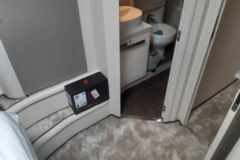  Yacht Photos Pics Interior of 2005 Mochi Dolphin 51 yacht showing bathroom and carpeted steps.