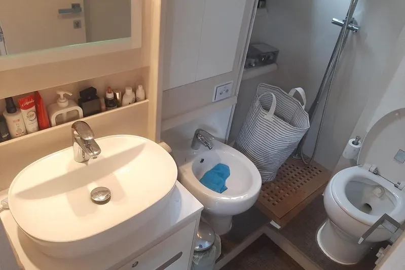  Yacht Photos Pics Compact bathroom in 2005 Mochi Dolphin 51 yacht with sink, bidet, and shower.