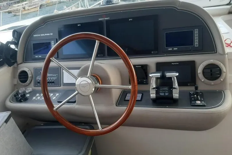  Yacht Photos Pics Cockpit of 2005 Mochi Dolphin 51 yacht with steering wheel and navigation controls.