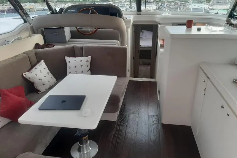  Yacht Photos Pics Interior of 2005 Mochi Dolphin 51 yacht with modern seating and table setup.