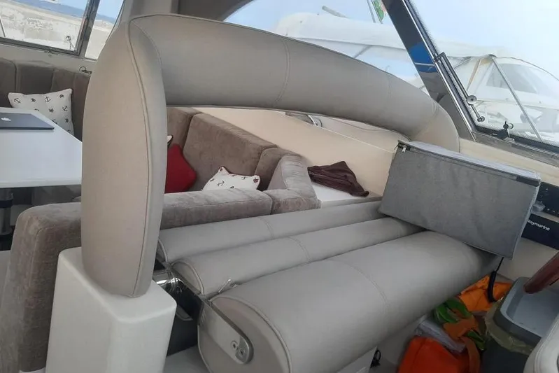  Yacht Photos Pics Interior of 2005 Mochi Dolphin 51 yacht with beige seating and modern decor.