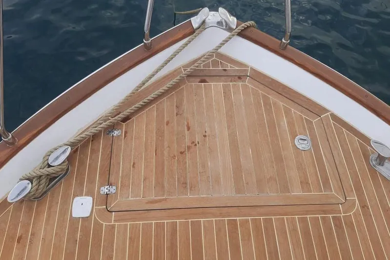  Yacht Photos Pics Bow of 2005 Mochi Dolphin 51 yacht with wooden deck and rope details.