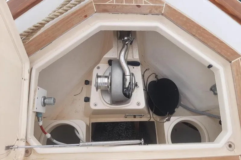  Yacht Photos Pics Anchor compartment of 2005 Mochi Dolphin 51 yacht, featuring winch and storage spaces.