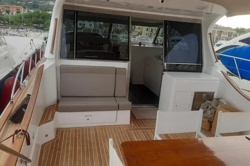  Yacht Photos Pics Interior view of 2005 Mochi Dolphin 51 yacht with seating and wooden flooring.