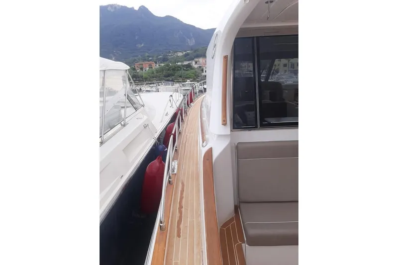  Yacht Photos Pics 2005 Mochi Dolphin 51 yacht docked with scenic mountain backdrop.