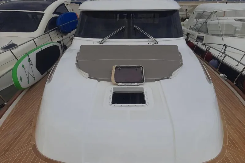  Yacht Photos Pics 2005 Mochi Dolphin 51 yacht with sleek deck design and paddleboard on the side.