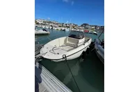 2023 Quicksilver Activ 675 Open boat docked in a marina under clear blue skies.