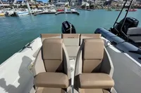 2023 Quicksilver Activ 675 Open boat with twin seats, docked in a marina.