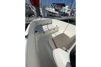 2023 Quicksilver Activ 675 Open boat interior with seating, docked at marina.