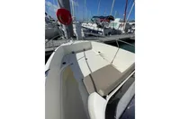 2023 Quicksilver Activ 675 Open boat interior at marina, featuring seating and deck area.