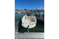 2023 Quicksilver Activ 675 Open boat docked in a marina under clear blue skies.