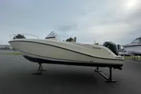 2023 Quicksilver Activ 675 Open boat displayed on a stand outdoors.