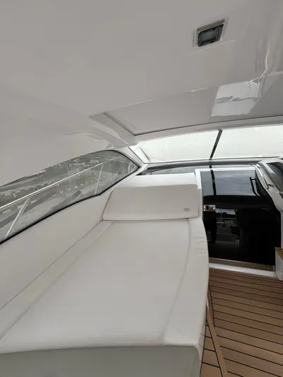 New Sessa C38 Yacht Photos Pics 2024 Sessa Marine C38 yacht interior with sleek white seating and wooden flooring.