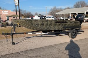 2026 Tracker Grizzly 1650 T Prairie Wings Edition boat on trailer, parked outdoors.
