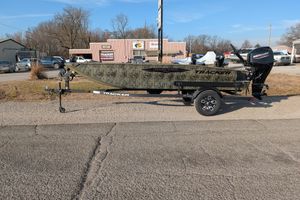2026 Tracker Grizzly 1650 T Prairie Wings Edition boat on trailer, parked outdoors.