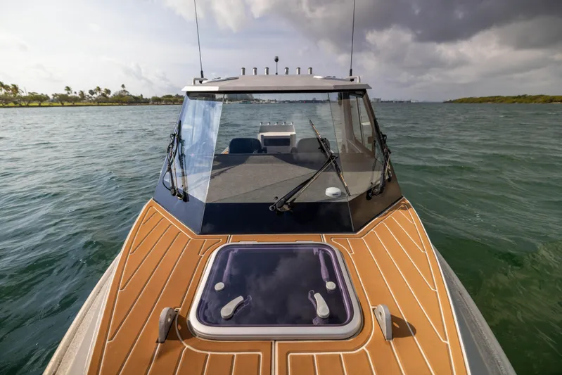 Latitude Yacht Photos Pics 2022 Sealegs 8.5M boat on water, featuring sleek design and wooden deck.