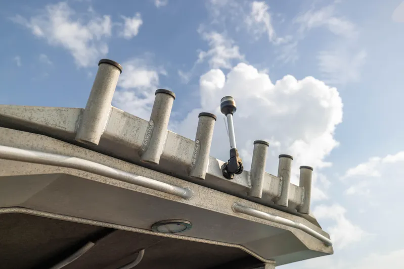 Latitude Yacht Photos Pics Sealegs 8.5M 2022 boat roof with rod holders against a cloudy sky.