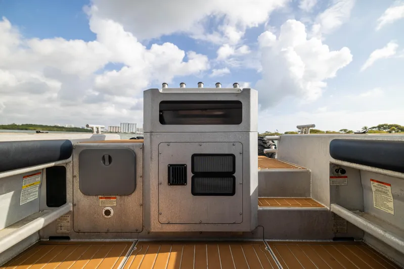 Latitude Yacht Photos Pics 2022 Sealegs 8.5M boat interior with control panel, wooden flooring, and clear sky.