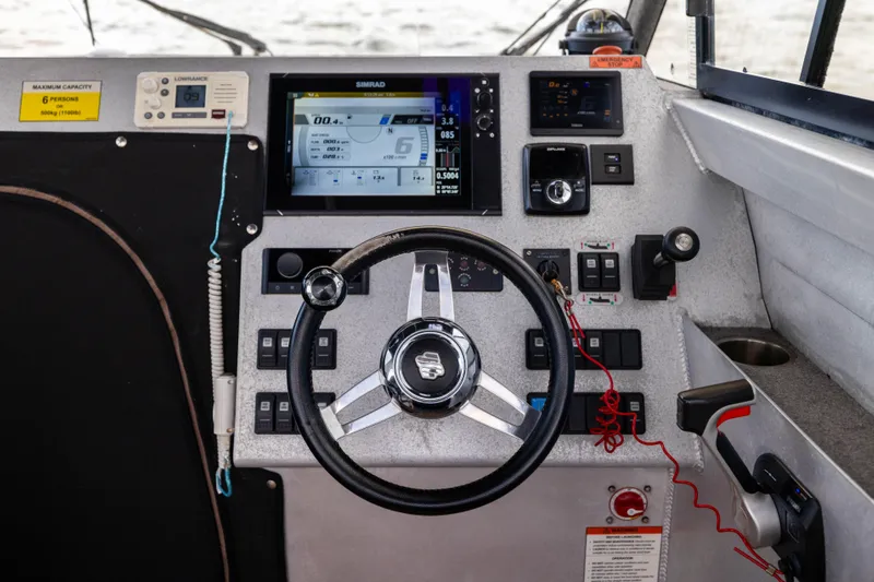 Latitude Yacht Photos Pics Control panel of a 2022 Sealegs 8.5M boat with steering wheel and navigation display.