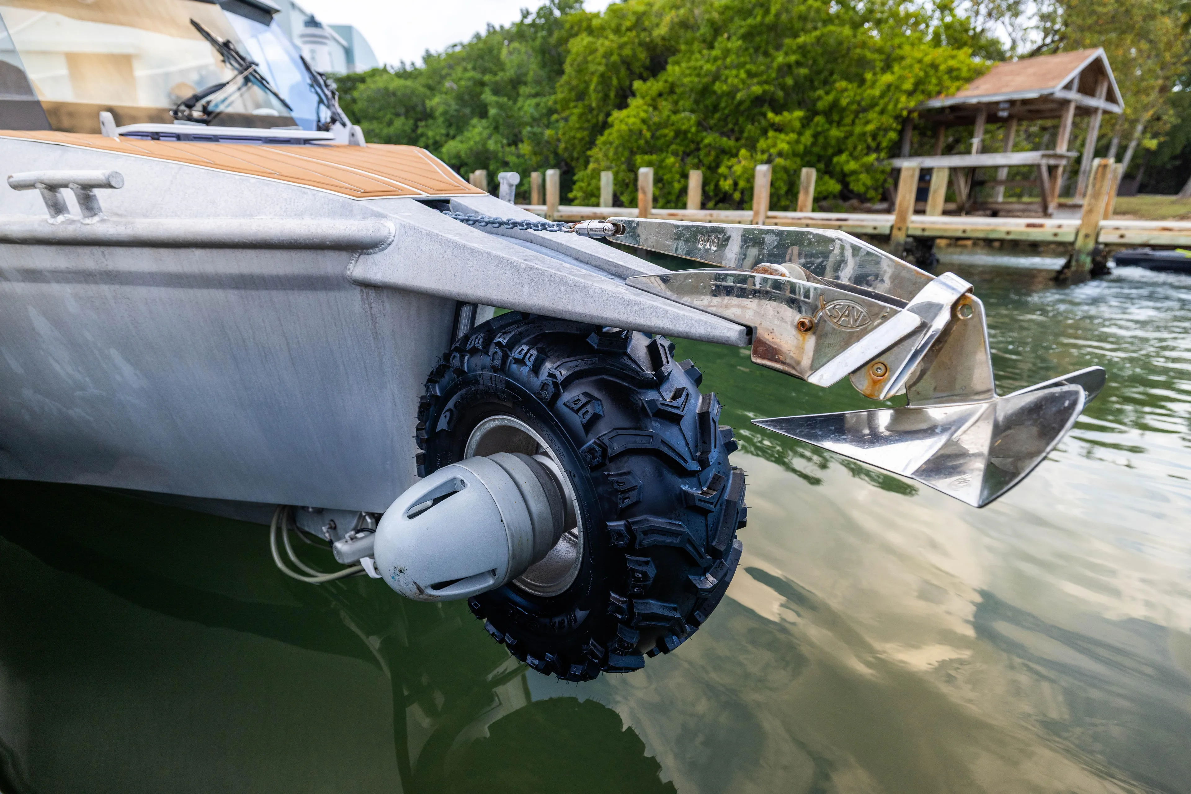 Latitude Yacht Photos Pics Amphibious Sealegs 8.5M boat with retractable wheels, 2022 model, near a dock.