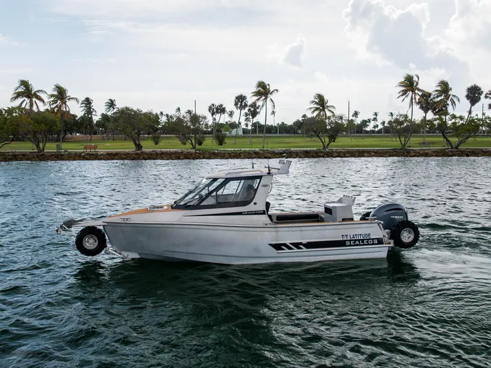 Latitude Yacht Photos Pics 2022 Sealegs 8.5M boat on water with palm trees in the background.