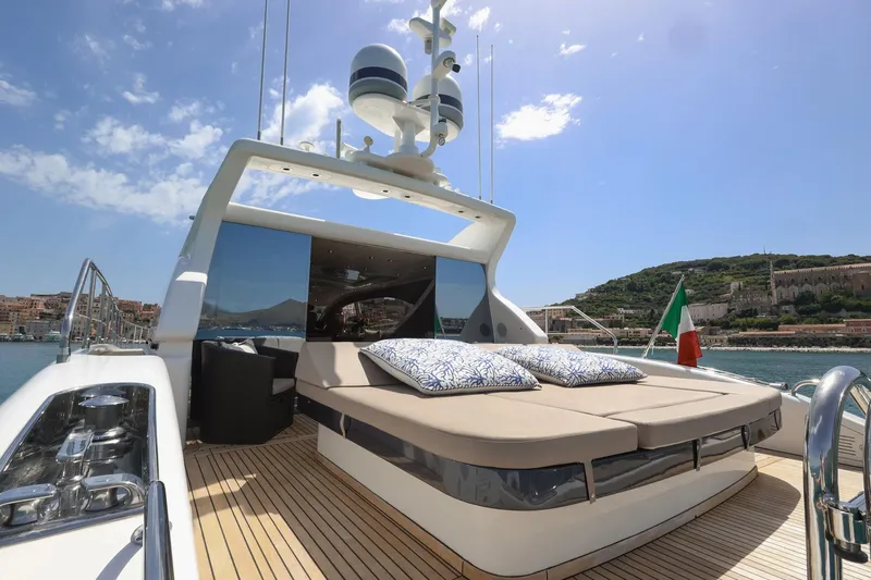 @last Yacht Photos Pics Luxury Leopard 24 yacht deck with sun loungers, Italian flag, and scenic coastal view.