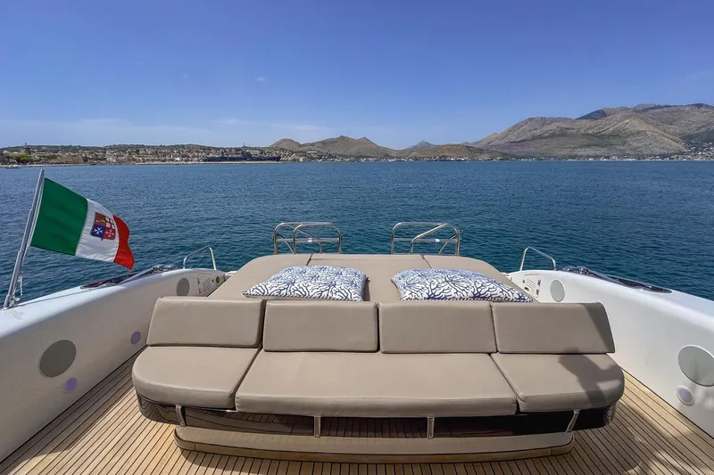 @last Yacht Photos Pics Luxury Leopard 24 yacht deck with sunbeds, Italian flag, and scenic ocean view.